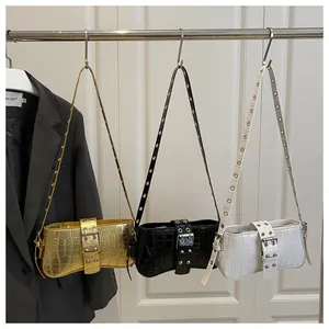 Detailed display of crocodile pattern shoulder bags in gold, black, and white leather