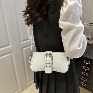White faux crocodile shoulder bag with metallic buckle shown styled on a model
