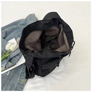Detail view of large black canvas waist bag with zipper closure and mesh side pocket
