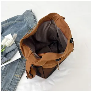 Detail view of khaki sports chest bag showing the zipper closure and dark grey inner lining