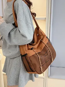 Brown canvas sling bag with mesh detail and USA lettering for women and sports