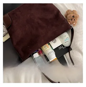 Top view of large brown suede tote bag showing internal capacity with daily essentials
