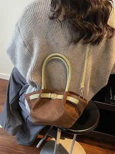 Retro brown suede bucket bag with green handles and pleated design for women