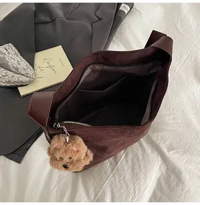 Interior view of large faux suede tote bag with zip closure and plush bear charm