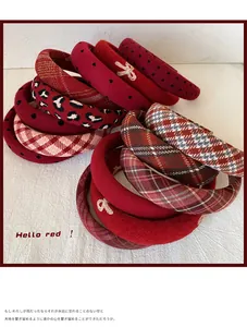 Close-up of festive red padded headbands featuring velvet and assorted checkered textures