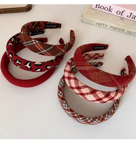 Close-up of assorted plaid and leopard print fabric headbands with handmade labels