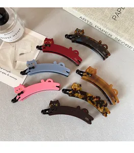 Collezione di fermacelli a banana a forma di gatto in sette colori e motivi eleganti