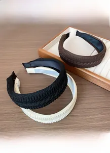 Detailed knit texture of woven headbands in brown, black, and beige colors