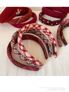Detailed view of handmade red festive headbands with various patterns and labels