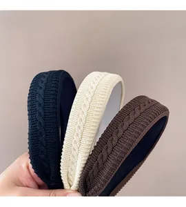 Close-up of knit headbands showing braided wool texture in black, beige and coffee