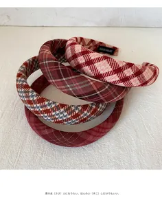 Detail showing various plaid headbands with high-quality fabric texture and handmade labels