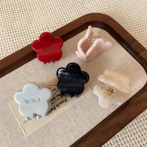 Set of five mini flower-shaped cream hair claws in red, pink, blue, grey and white