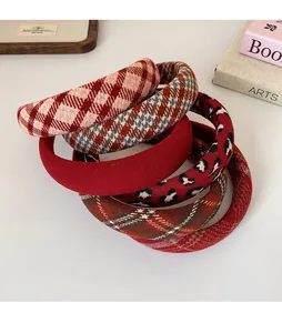Detail of assorted red plaid and leopard print padded headbands for chic hairstyles