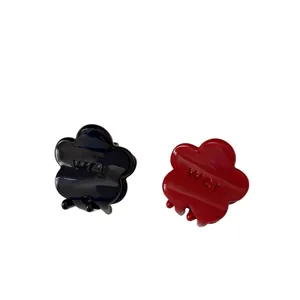 Glossy cream flower hair claws in black and red with elegant flower petal design