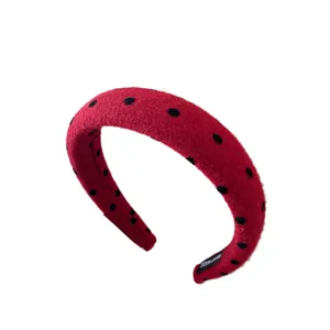 Red velvet padded headband with black polka dots and handmade label detail