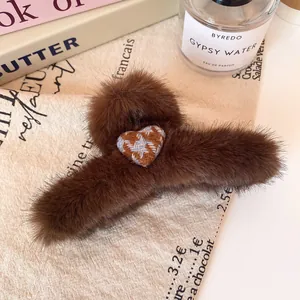 Brown faux fur hair claw clip featuring a blue checkered heart embroidery on soft plush