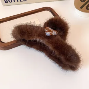 Brown faux fur heart hair claw clip with plush texture and checkered pattern