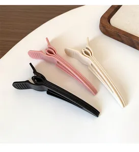 Three-piece set of matte hair root clips in black, pink, and off-white colors