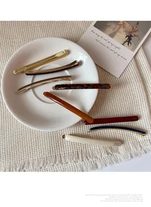 Detail of multi-colored long acetate hair clips set with France Handmade engraving