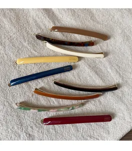 Detailed view of colorful acetate hair clips with France Handmade gold engraving