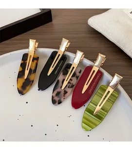 Close-up of vintage acetate duckbill clips in various patterns with France engraving