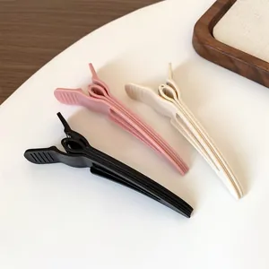 Three-piece hair root volumizing clips in pink, beige, and black for natural styling
