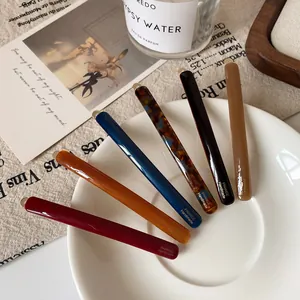 Slim acetate hair clips set in 6 assorted colors with handmade gold-tone accents