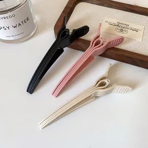 Matte volume hair clips set in black pink and beige for hair root lifting and styling