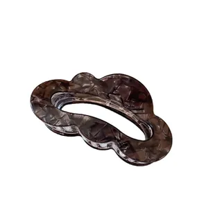 Translucent dark brown cloud-shaped shark hair clip with a wavy edge and cracked texture