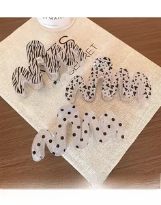 Three-piece set of glitter resin claw clips featuring zebra, heart, and polka dot patterns
