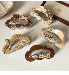 Detailed set of 5 cute cloud-shaped hair claws with vintage patterns and Unique text