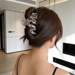 Elegant wave-shaped large leopard print hair claw clip shown on a model hair bun