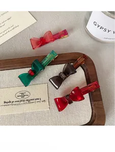 Detail of colorful acrylic bow hair clips with France Handmade text on wooden tray