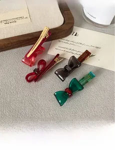 Close-up of four colorful acrylic bow hair clips with Korea and France handmade marks