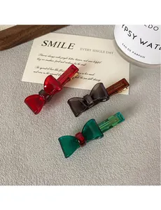Close-up of translucent colorful resin bow hair clips with France Handmade text detail