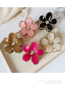 Detailed set of candy-colored gradient flower hair claws with elegant gold edges