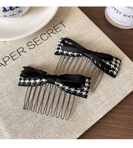 Detail of two-piece metal hair combs with elegant black and white houndstooth bowknots