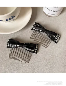 Close-up of houndstooth bow hair combs with metal teeth on a minimalist aesthetic background