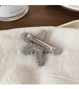 Detailed back view of a silver star-shaped hair clip with textured metallic finish