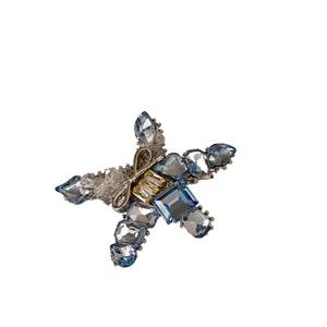 Elegant star-shaped hair clip featuring sparkling blue and yellow crystals on silver base