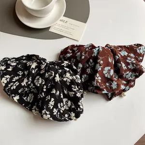 Floral chiffon bow scrunchies with white pearl trim in black and brown floral patterns