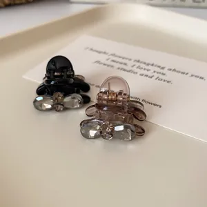 Elegant bow hair claws with sparkling rhinestones in black and amber brown colors
