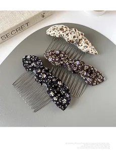 Three-piece floral bow hair combs in black, dark coffee and beige on a display mat