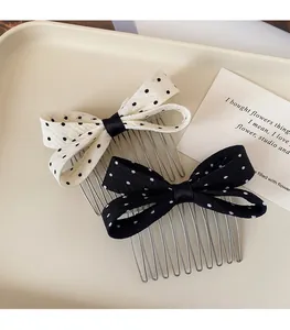 Close-up of polka dot bow hair combs with silver metal teeth for stylish hairstyling