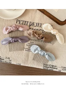 Set of 5 satin bow hair combs in pastel colors including pink blue and champagne tones