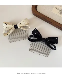 Detailed view of polka dot bow hair combs with metal teeth in black and white fabric