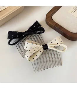 Close-up of polka dot bow hair combs with textile texture and metal teeth for styling
