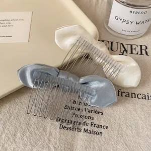 Elegant satin bow hair combs in cream and blue colors for sophisticated hairstyling