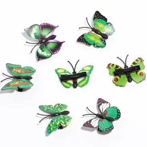 Detail showing 7-piece set of green butterfly hair clips with black metal duckbill base