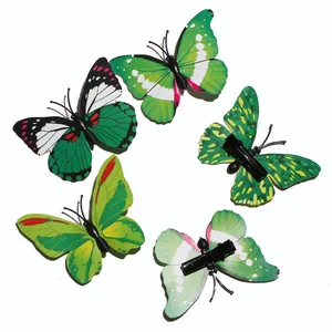 Detail view of five green butterfly hair clips showing realistic patterns and duckbill clips